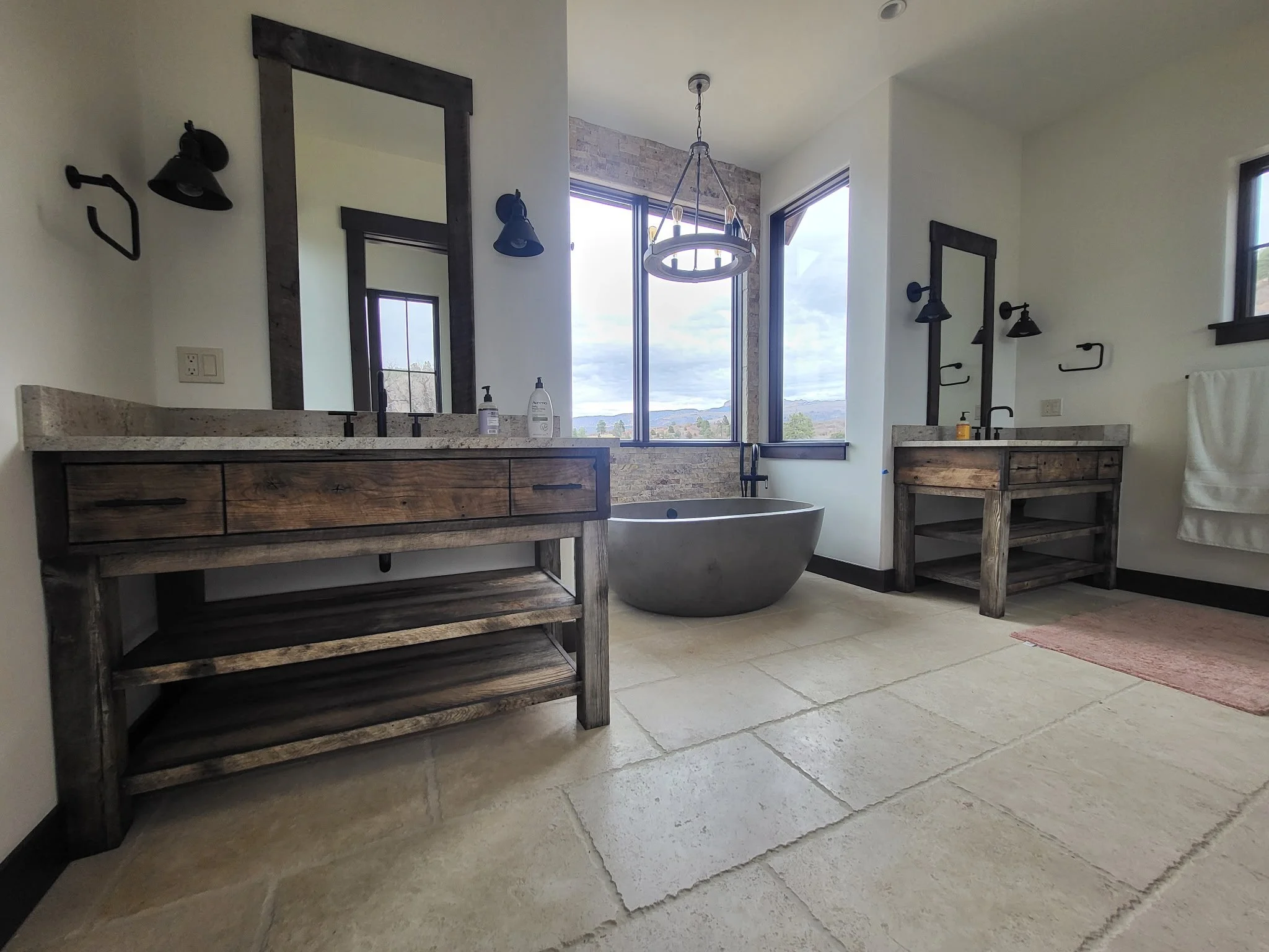 Furniture-style bathroom vanity with traditional legs, apron design, open storage shelves, and minimal drawer boxes—rustic cabin look with modern functionality.