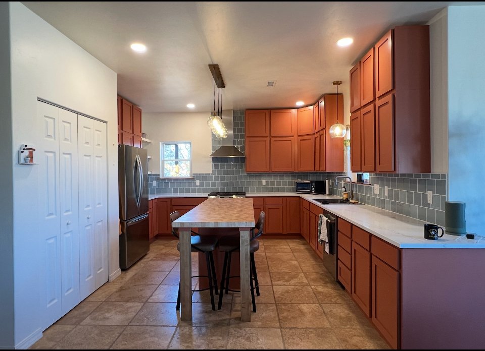 DIY kitchen remodel featuring cabinet refacing, new cabinet doors, custom-built island, and additional upper cabinets for extra storage—homeowner-installed, Animas Craft Woodworks made, in Durango.