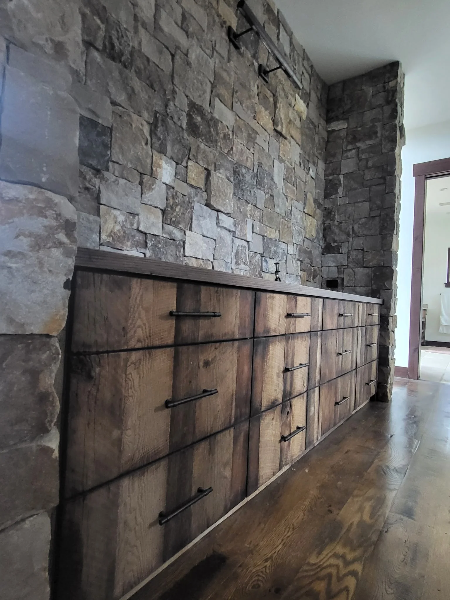 Custom reclaimed wood dresser featuring seamless vertical grain drawer fronts, rustic finish, and modern craftsmanship in master bedroom.