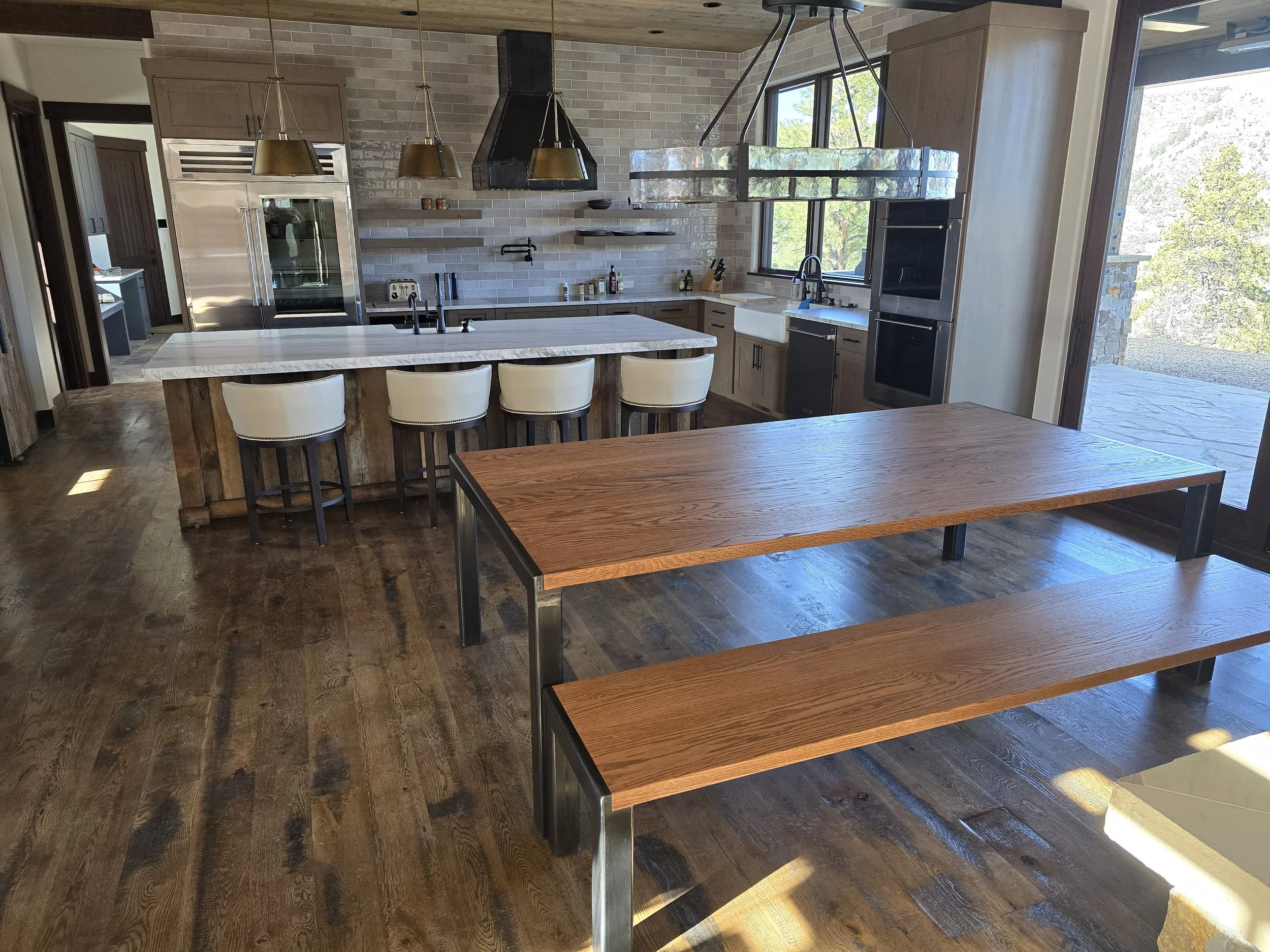 Custom oak and steel table with matching bench, featuring locally crafted steel legs and slightly distressed oak top—collaborative project by Animas Craft Woodworks.