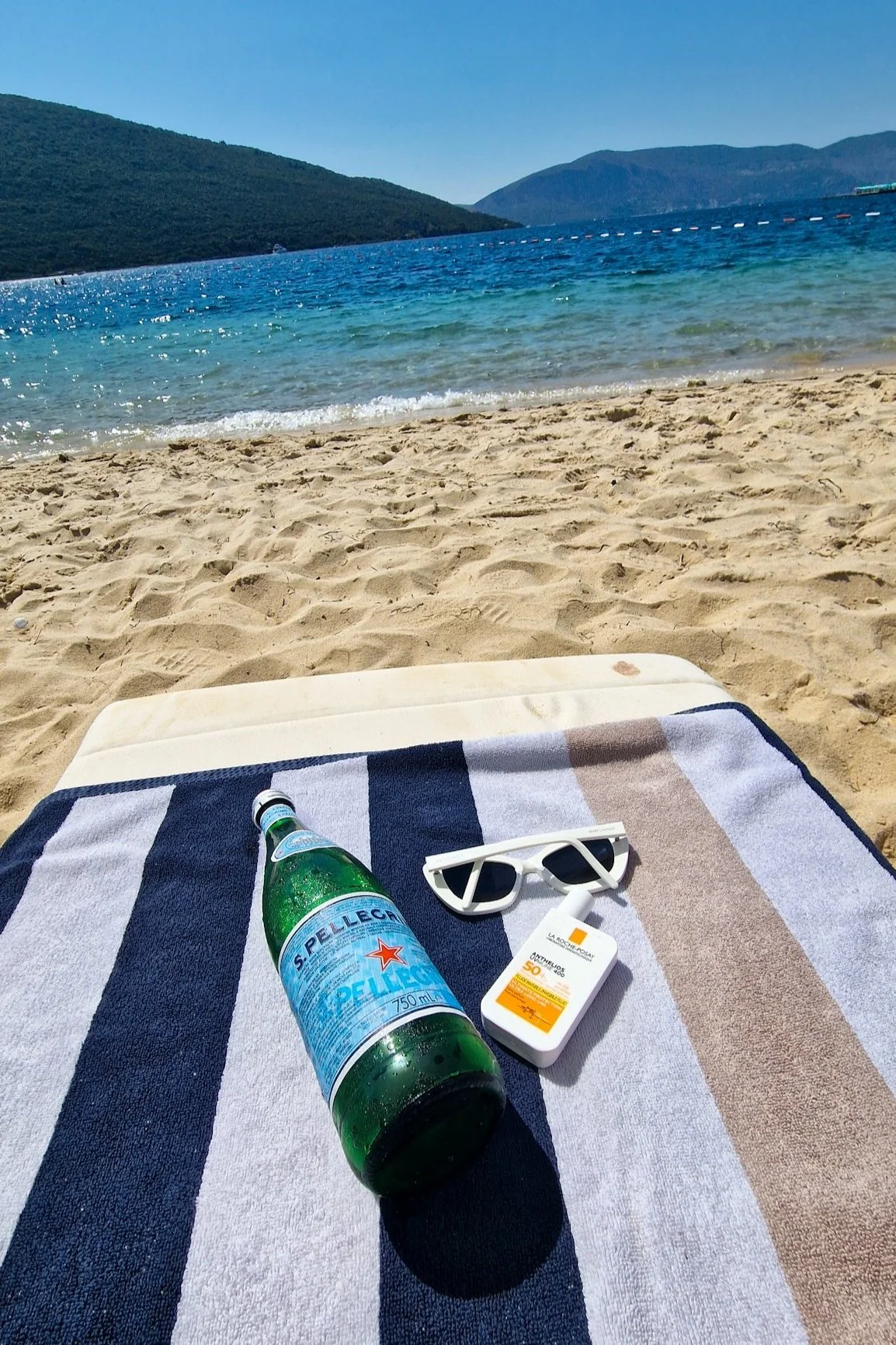 Summer essentials sunglasses la roche posay sunscreen pellegrino sparkling water
