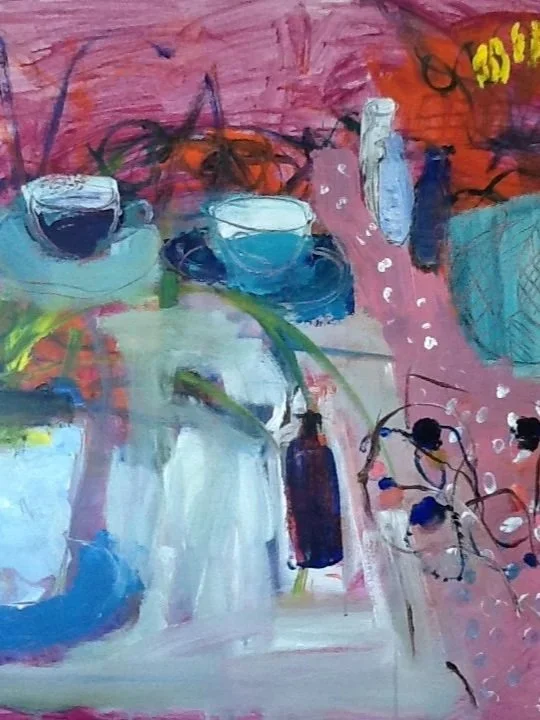 A colorful still life with cups, a bottle, and scattered objects on a pink and multicolored background.