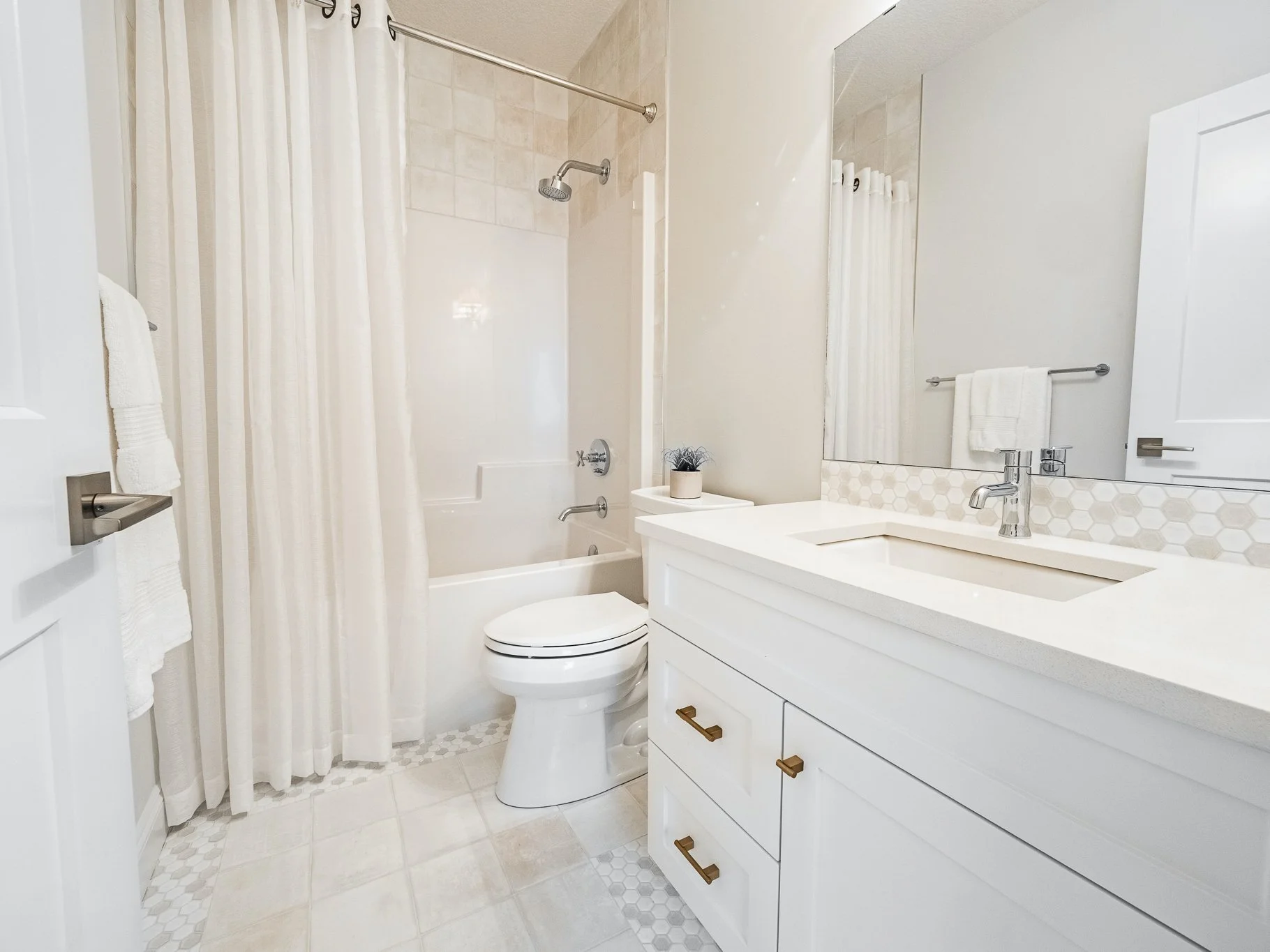 Main bathroom featuring custom floor tile work with a decorative border.