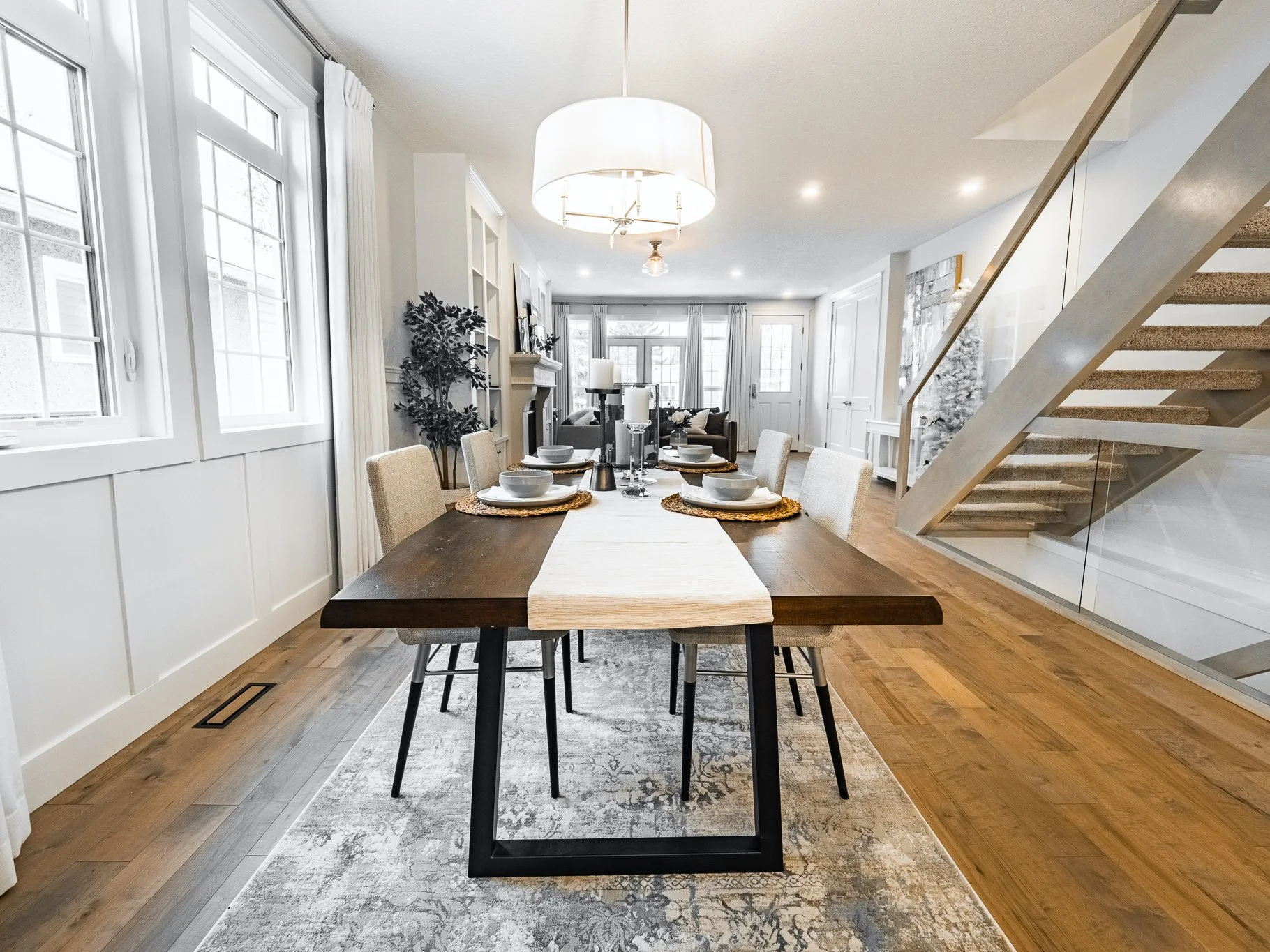 Custom millwork and Crate and Barrel chandelier in a dining area featuring Kentwood brushed maple floors in Tail Feather.