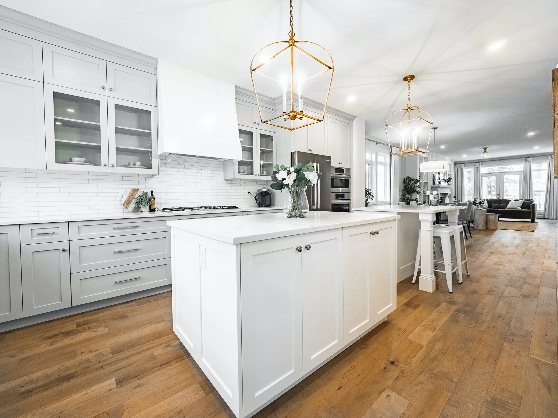 Open-concept kitchen with Tierra Sol Tempo handmade snow tile backsplash and Emtek Alexander pulls in polished nickel.