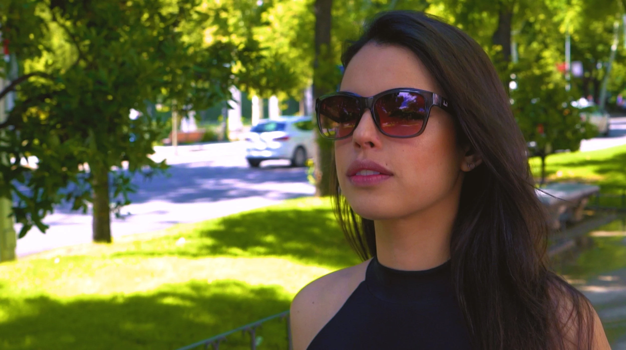 Woman wearing sunglasses in a park