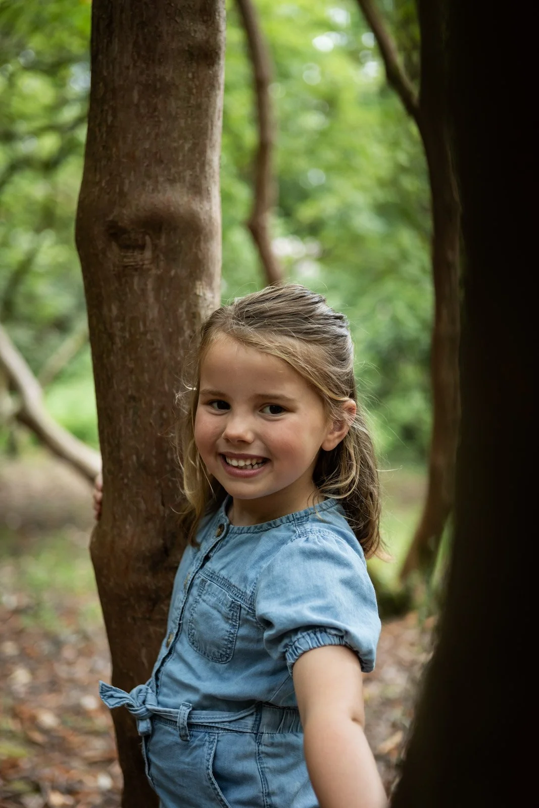 portrait of sister climbing tree family shoot