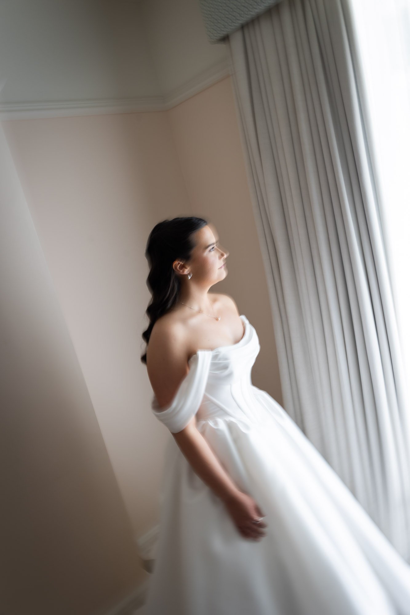 bride looking out over Cardiff from wedding venue bridal suite