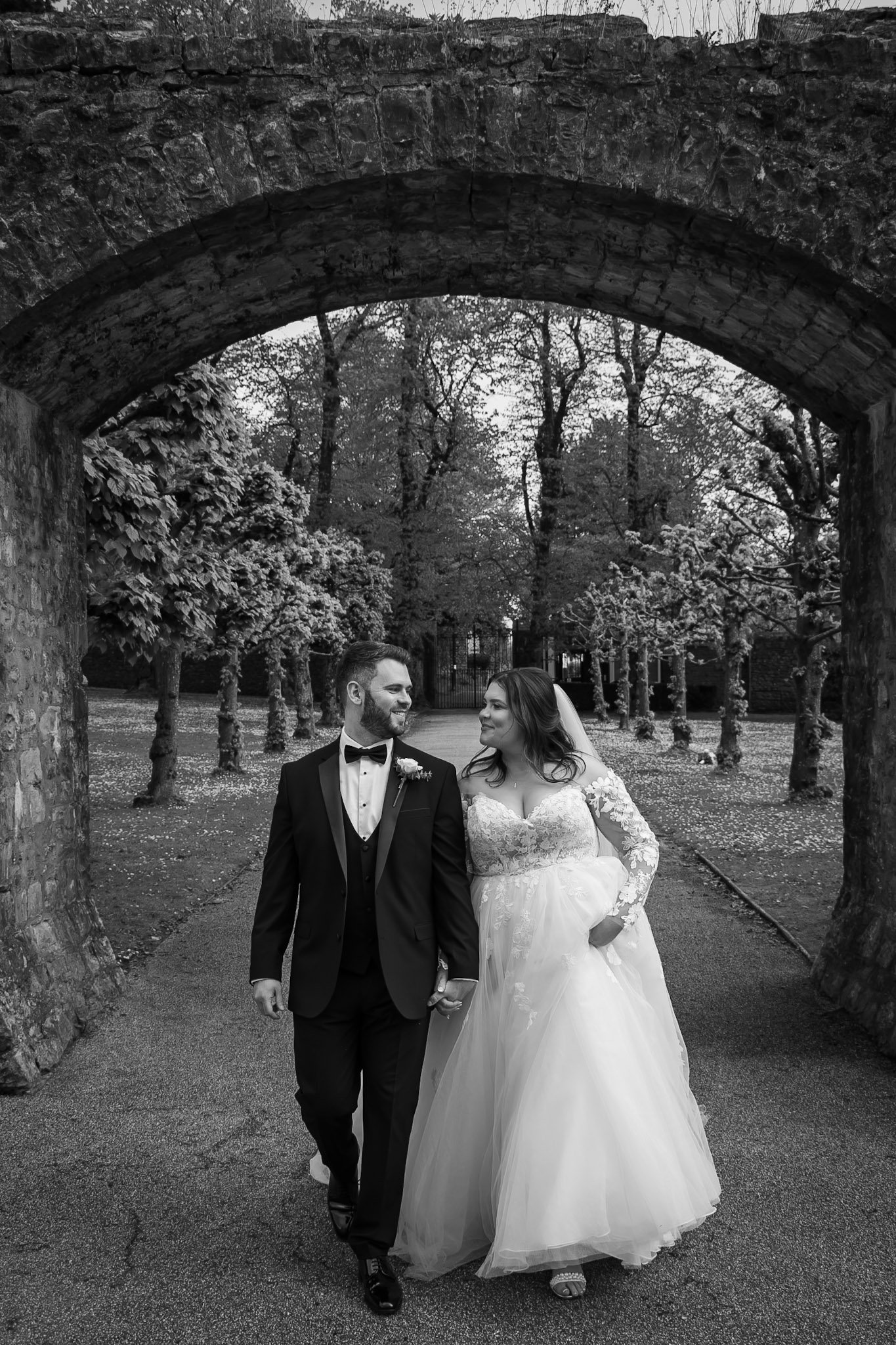 bride walking and smiling with husband cardiff