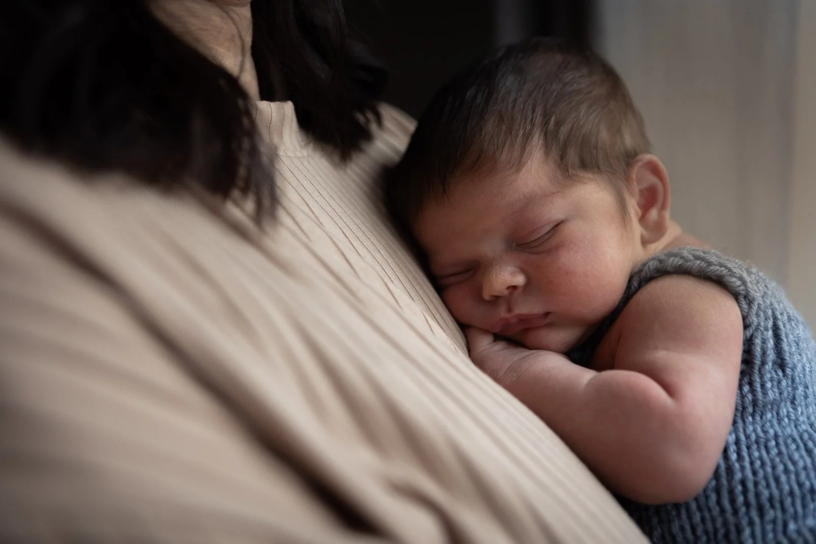 baby boy sleeps on mum's chest
