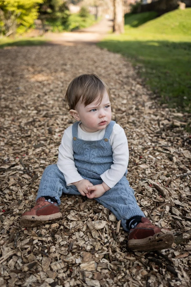 toddler sat on ground in Cardiff for family shoot portrait session