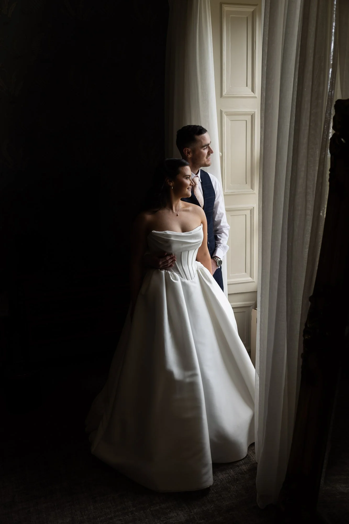bride and groom in window light