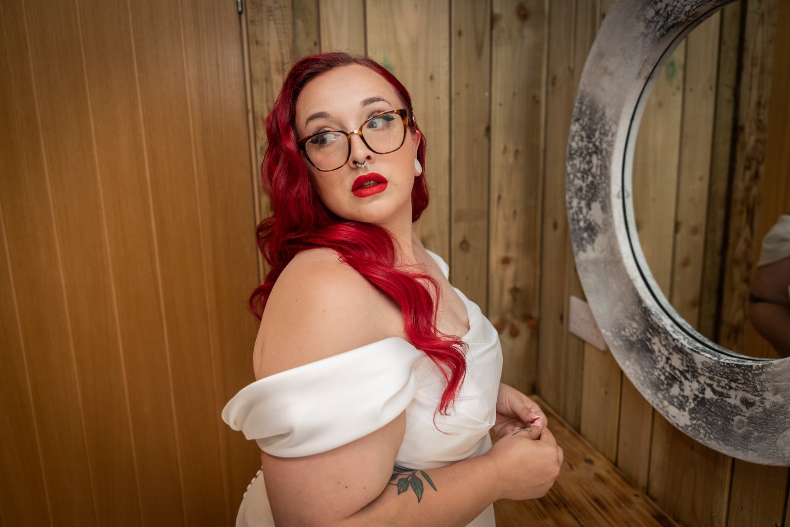 bride looking over shoulder with mirror in background