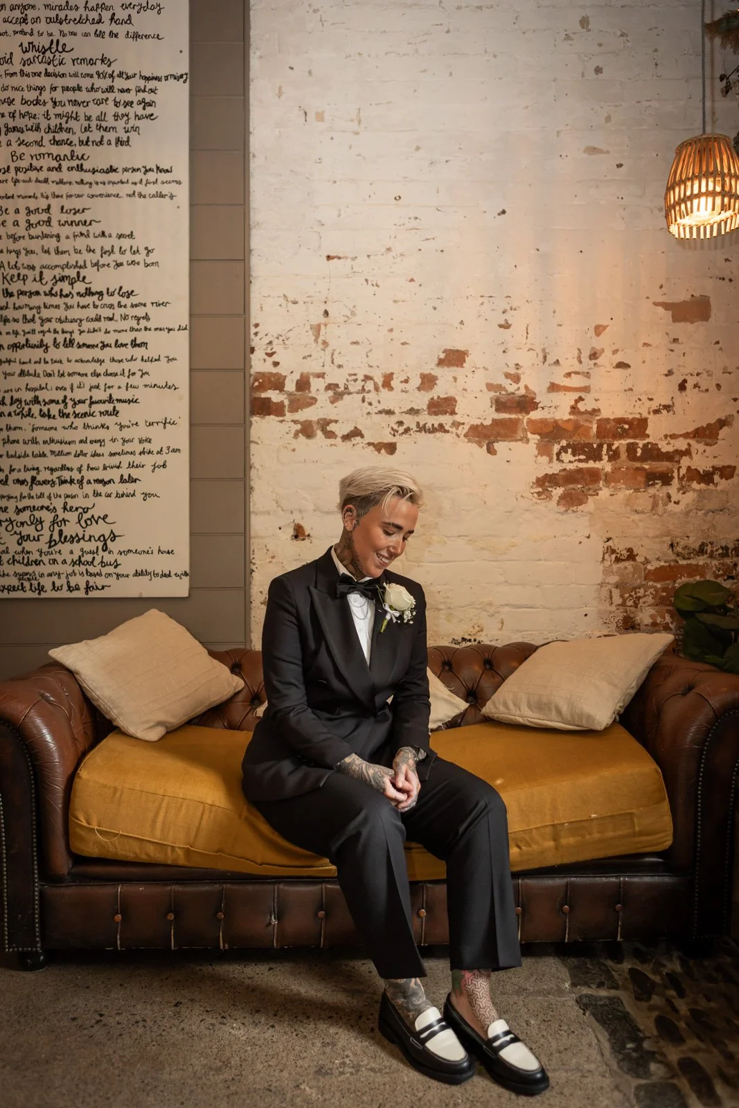 bride sat at Cobbles wedding venue on sofa in suite