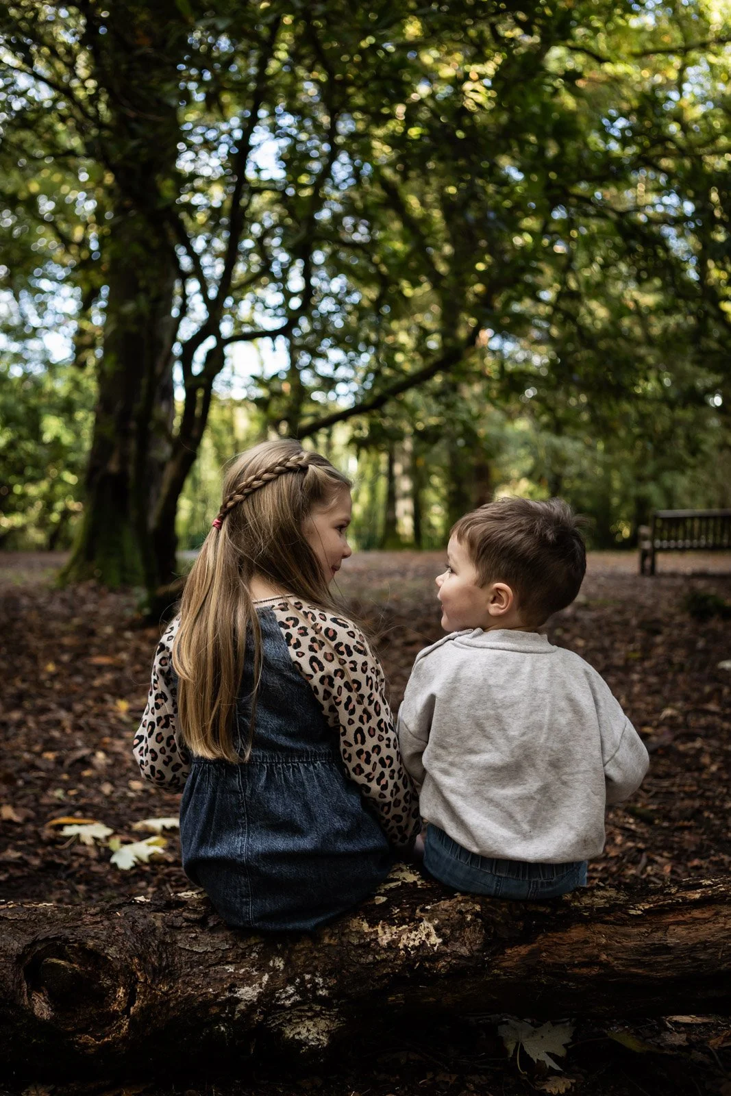 brother and sister sister on look facing away and looking at each other