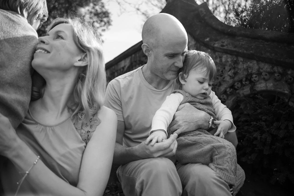 mother and son, father and son sat on steps at Insole Court for a family session