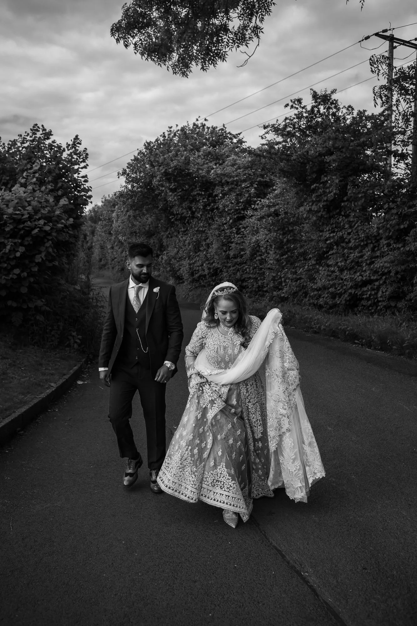bride and groom walking down lane