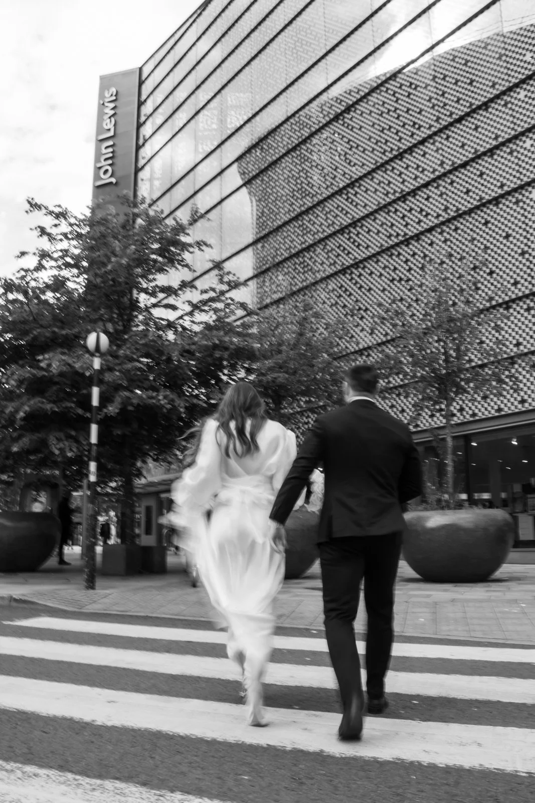 bride and groom walk hand in hand to restaurant 