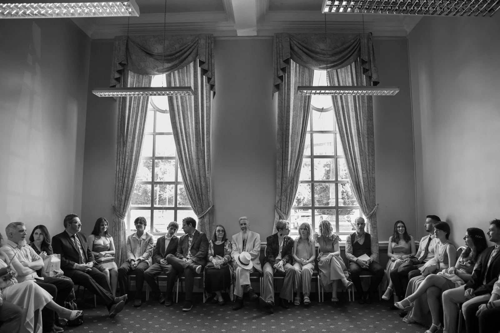 wedding guests wait in room before ceremony