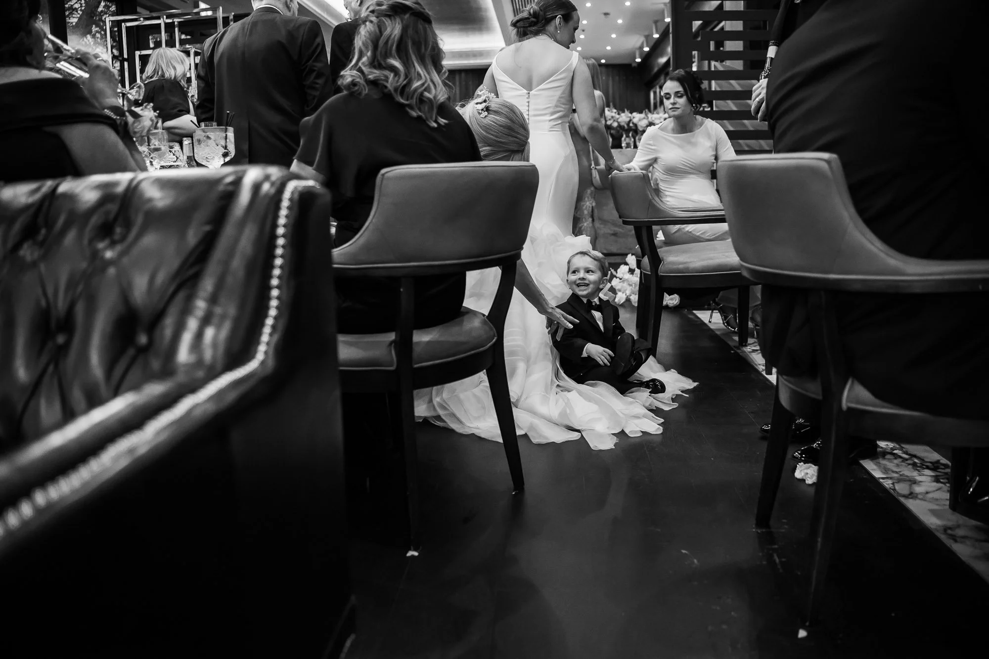 son of bride riding on wedding dress train at Sant Ffraed House