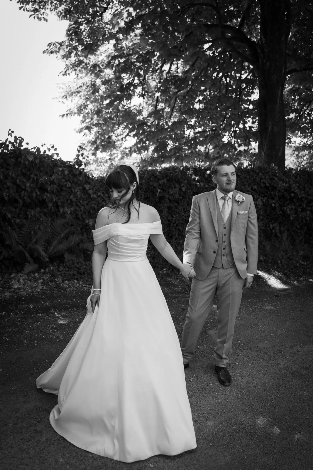 bride and groom at llechwen hall holding hands 