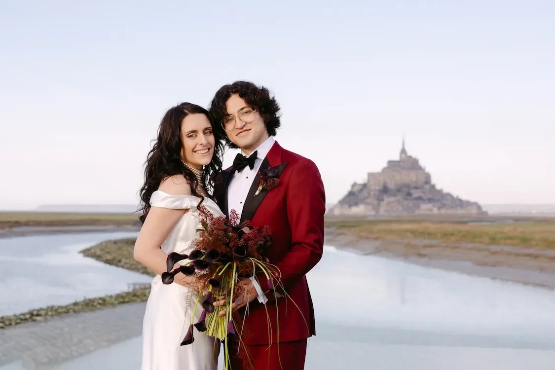Coiple elopement portrait in Mont Sait Michel with castle in the background in France