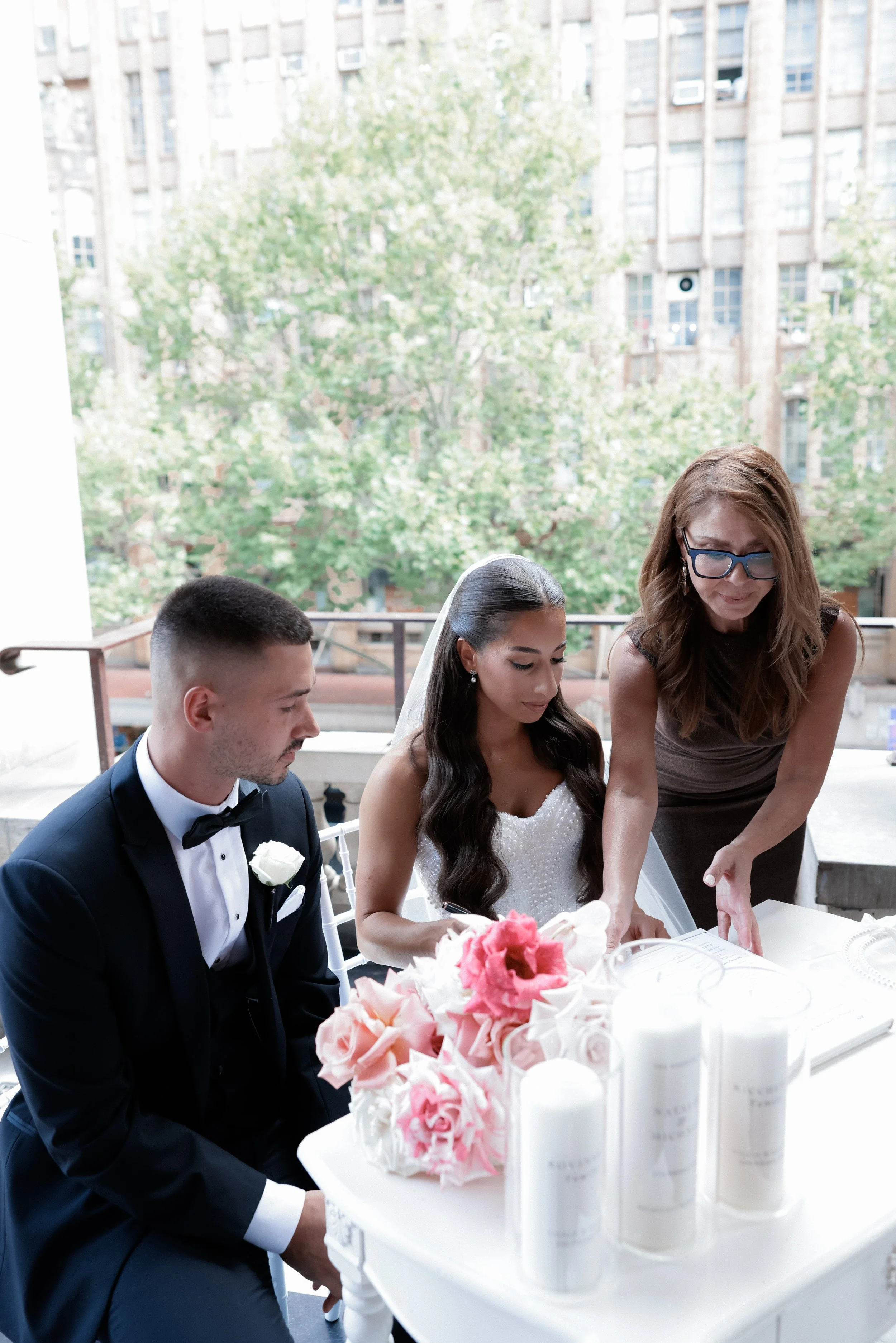 Irene Palamaras at signing table with couple