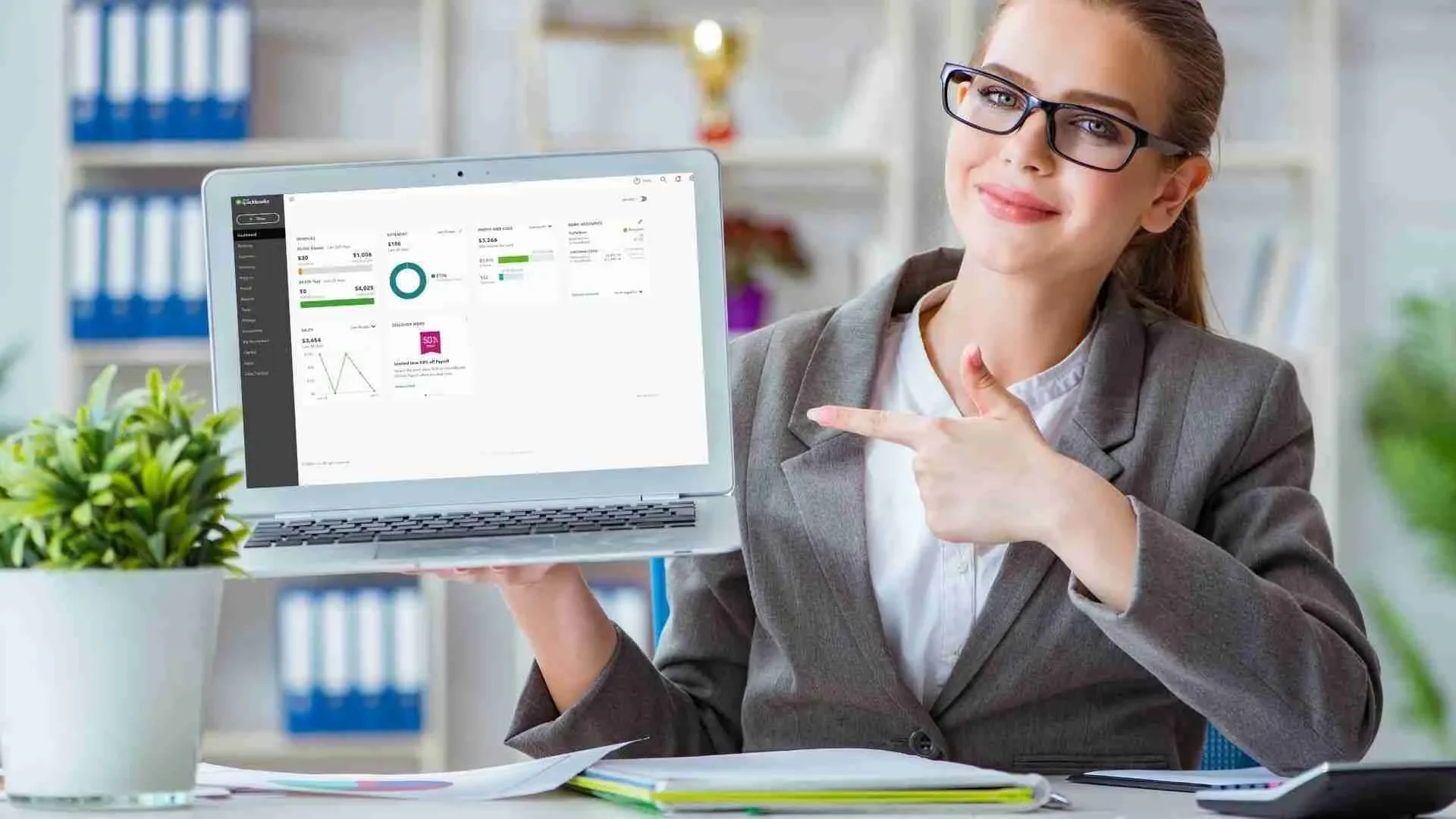 Business owner reviewing QuickBooks reports with a checklist for financial cleanup milestones