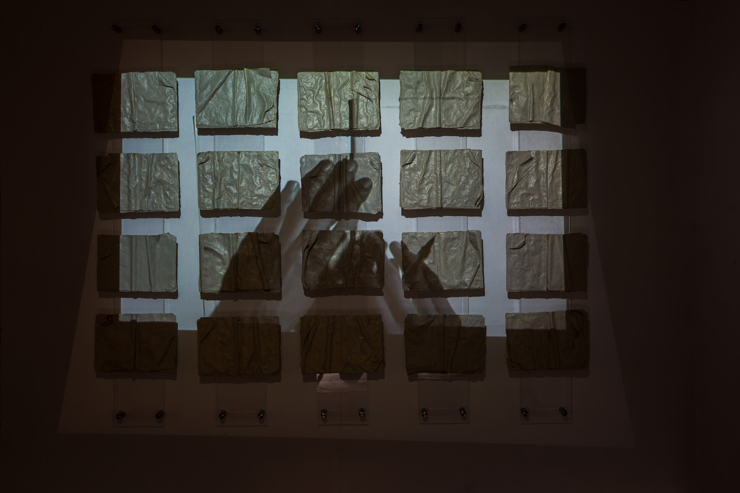 Film projection onto ceramic book wall installation