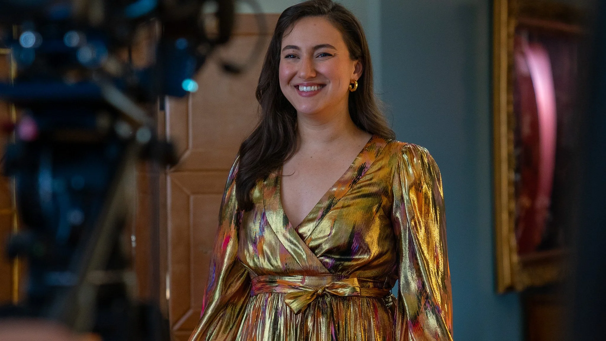 Ilse Zacharias Rivera on set in gold dress
