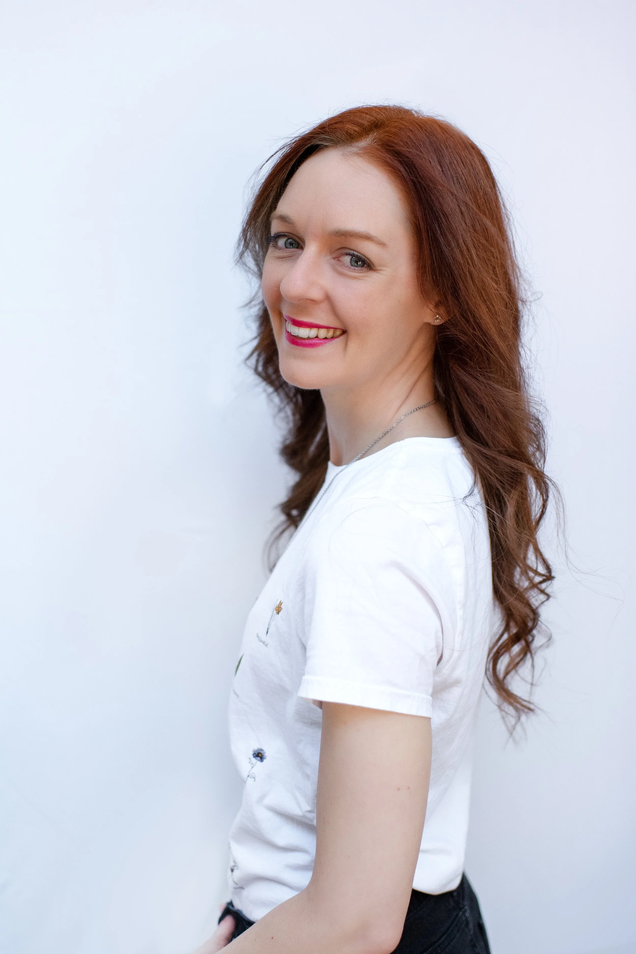 Headshot of Lucia looking over her shoulder