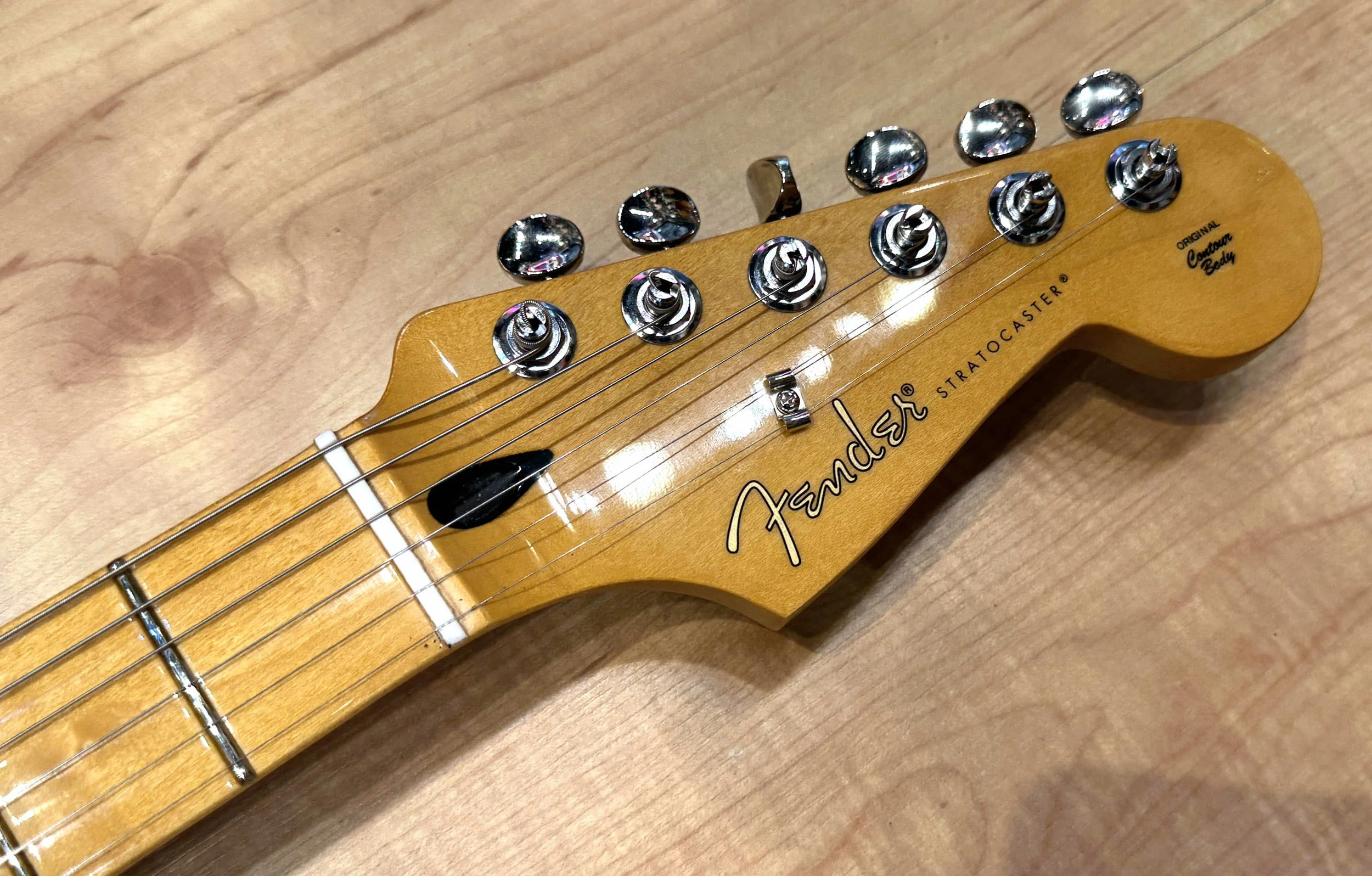 Headstock of the Fender Player II Stratocaster Electric Guitar In Rallye Orange