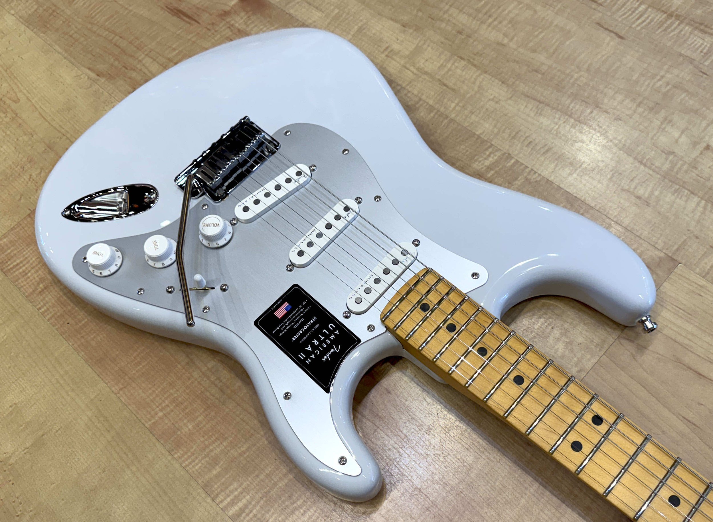 Pickguard of the Fender American Ultra II Stratocaster Electric Guitar In Avalanche White