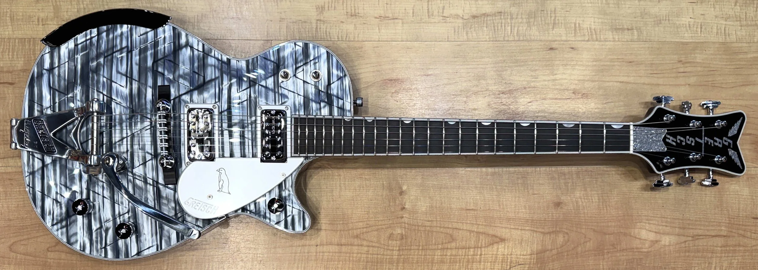 Front of the The Gretsch G6134T-58 Limited Edition Penguin with String-Thru Bigsby Electric Guitar In Light Blue Pearl