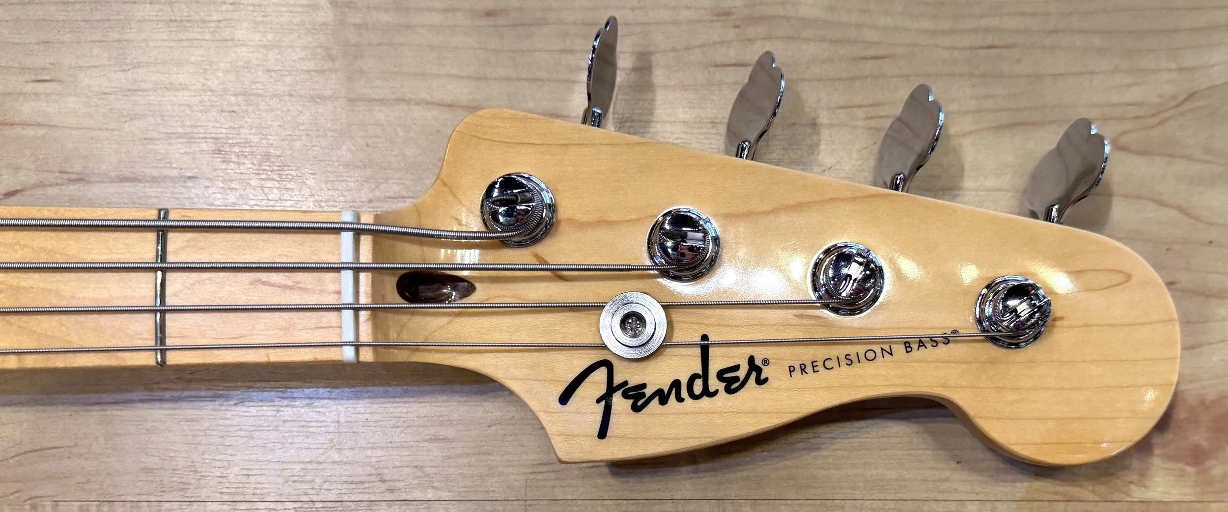 Headstock of the Fender Standard Precision Bass In Candy Apple Red