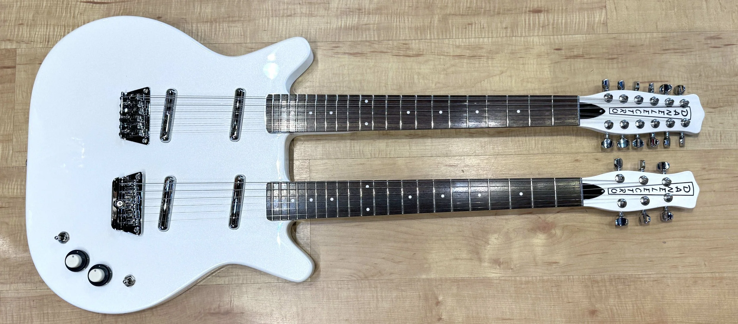 Front of the Danelectro Doubleneck 6/12 Electric Guitar In White Pearl