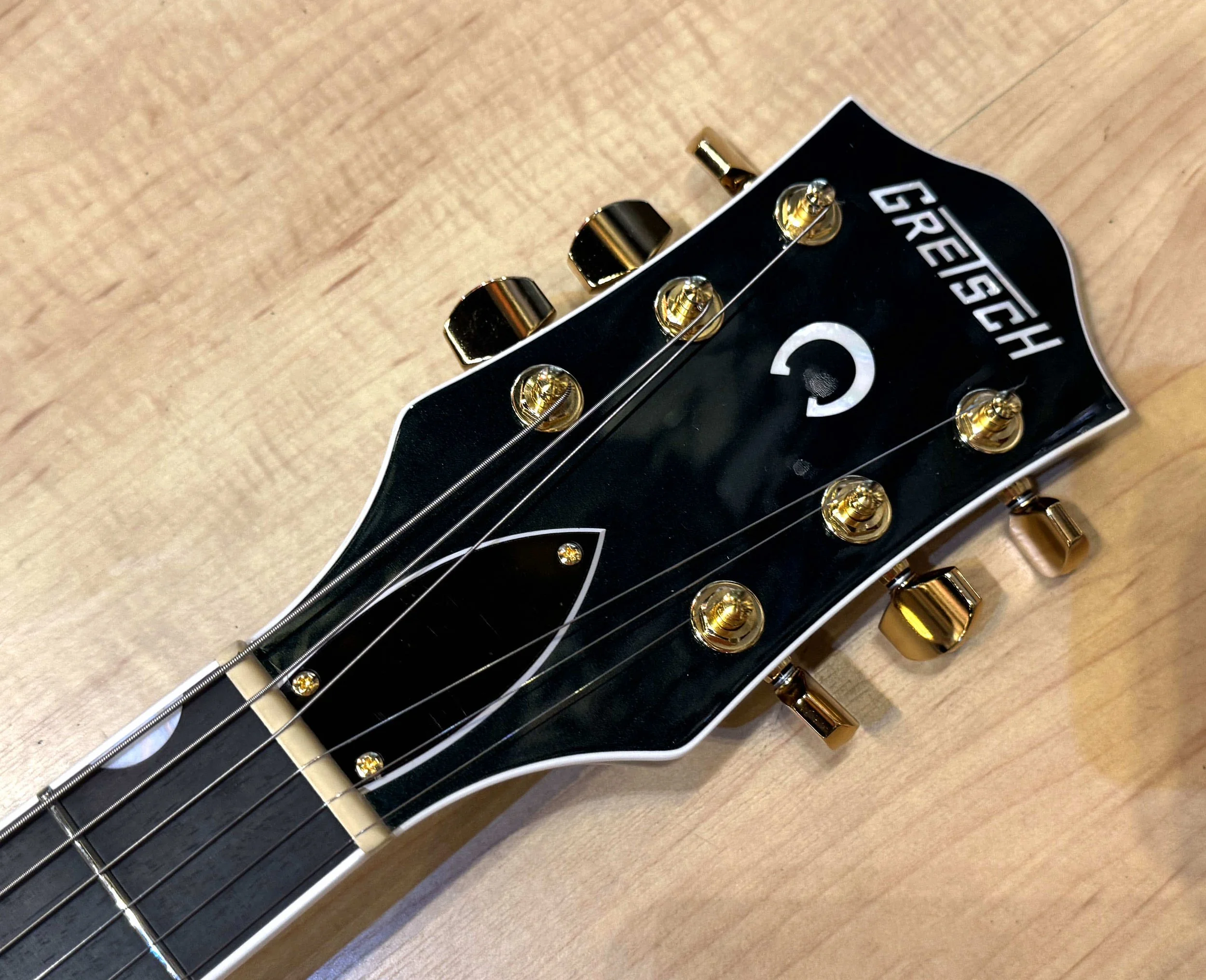 Headstock of the Gretsch 6120 Nashville Hollow Body with String-Thru Bigsby and Gold Hardware In Cadillac Green