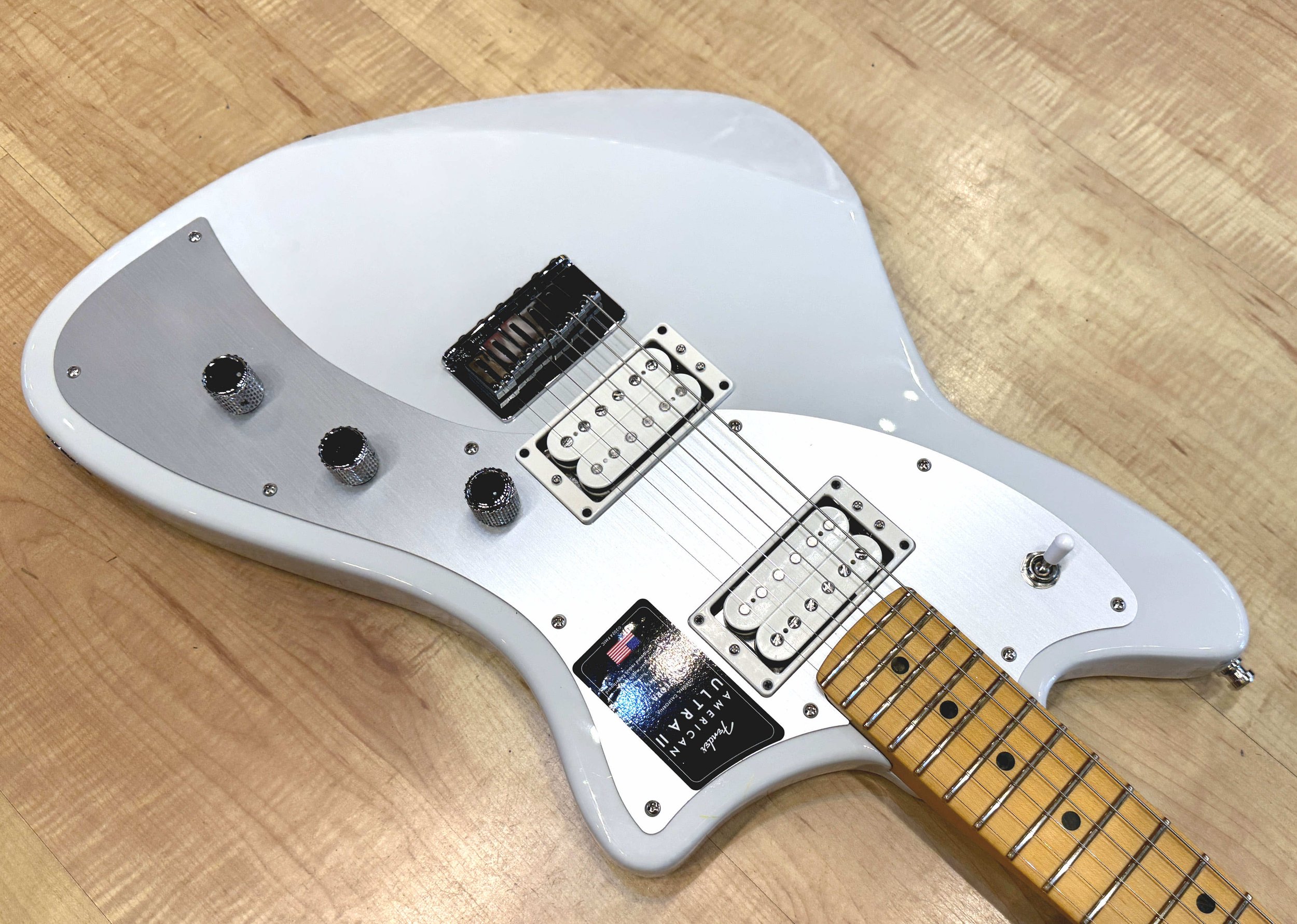 Pickguard of the Fender American Ultra II Meteora Electric Guitar In Avalanche White
