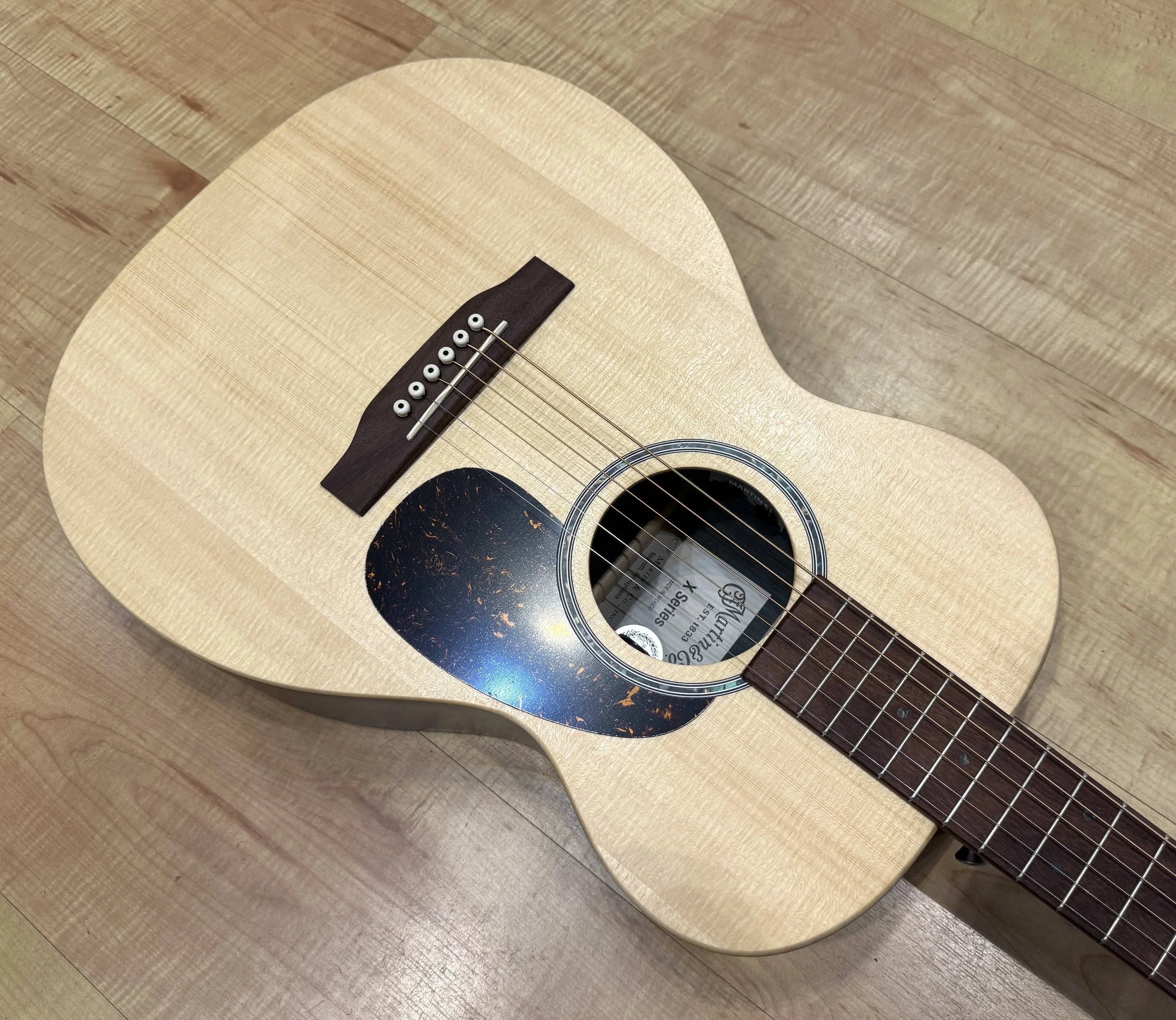 Pickguard of the Martin X Series 0-X2E Cocobolo Acoustic Electric Guitar