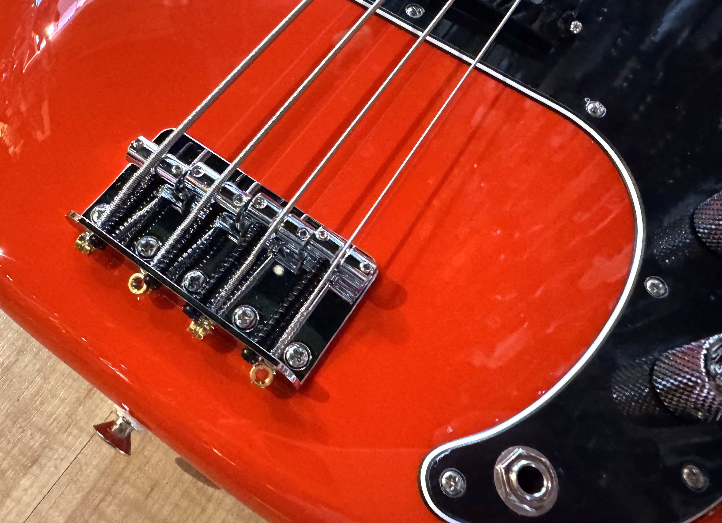 Bridge of the Fender Player II Precision Bass in Coral Red