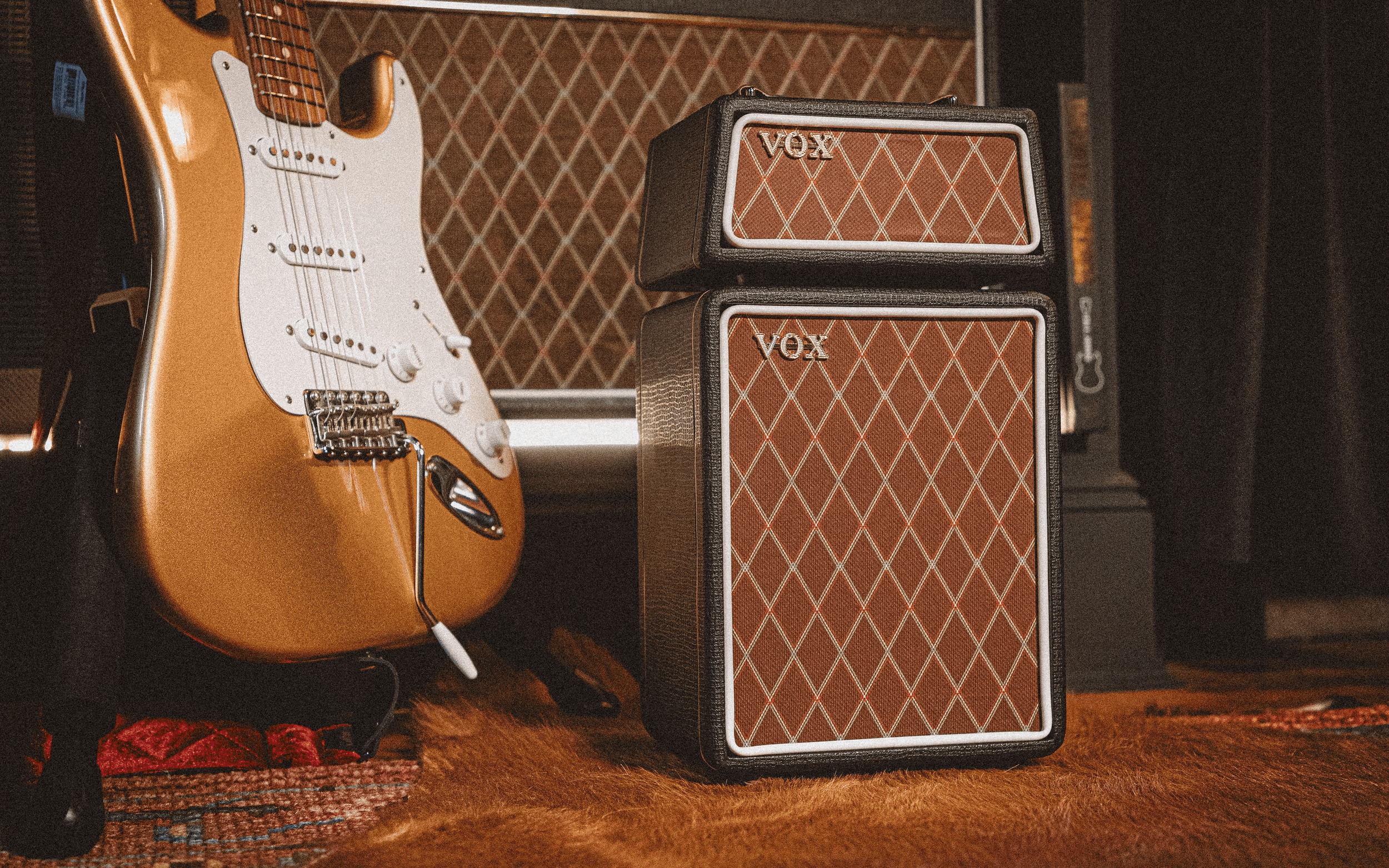 the VOX Micro Superbeetle Guitar Amp next to a fender strat