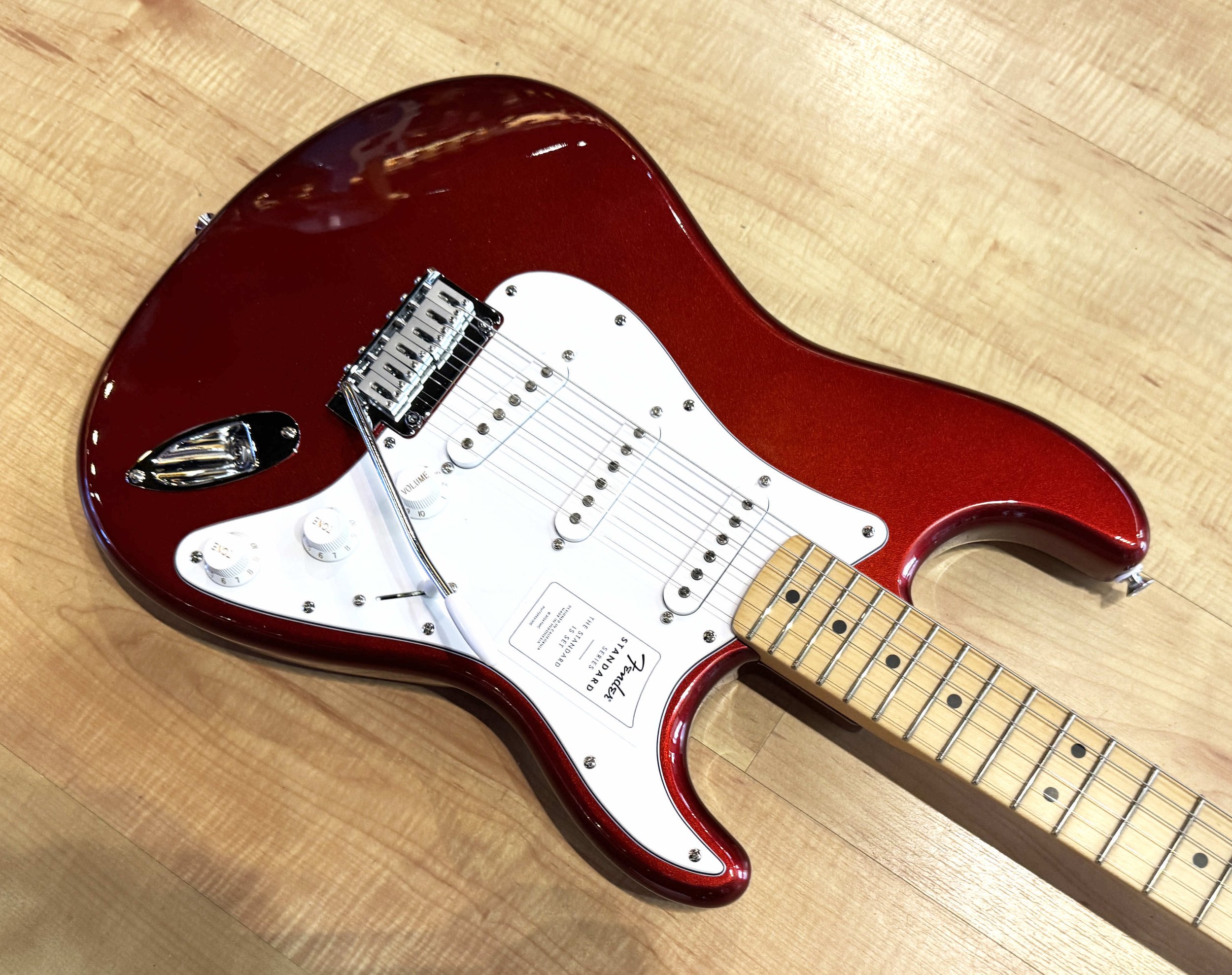 Pickguard of the Fender Standard Stratocaster Electric Guitar In Candy Cola