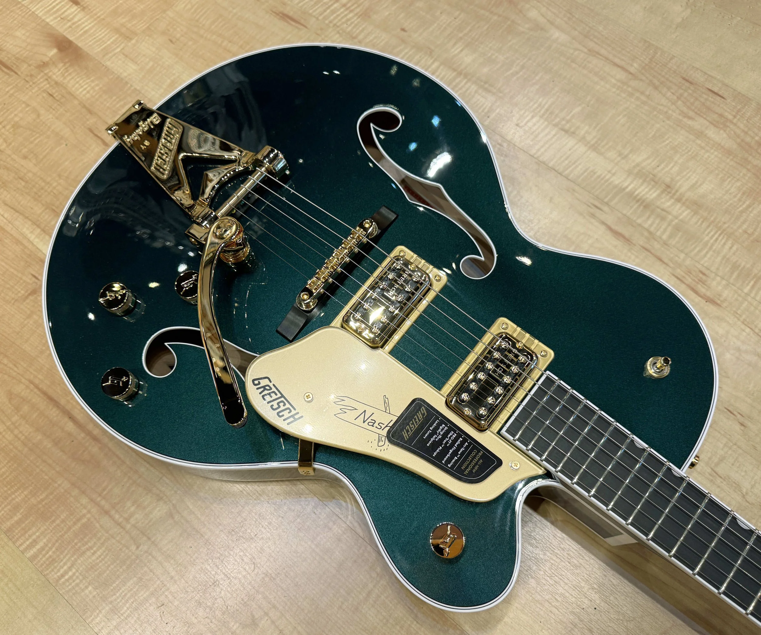 Pickguard of the Gretsch 6120 Nashville Hollow Body with String-Thru Bigsby and Gold Hardware In Cadillac Green