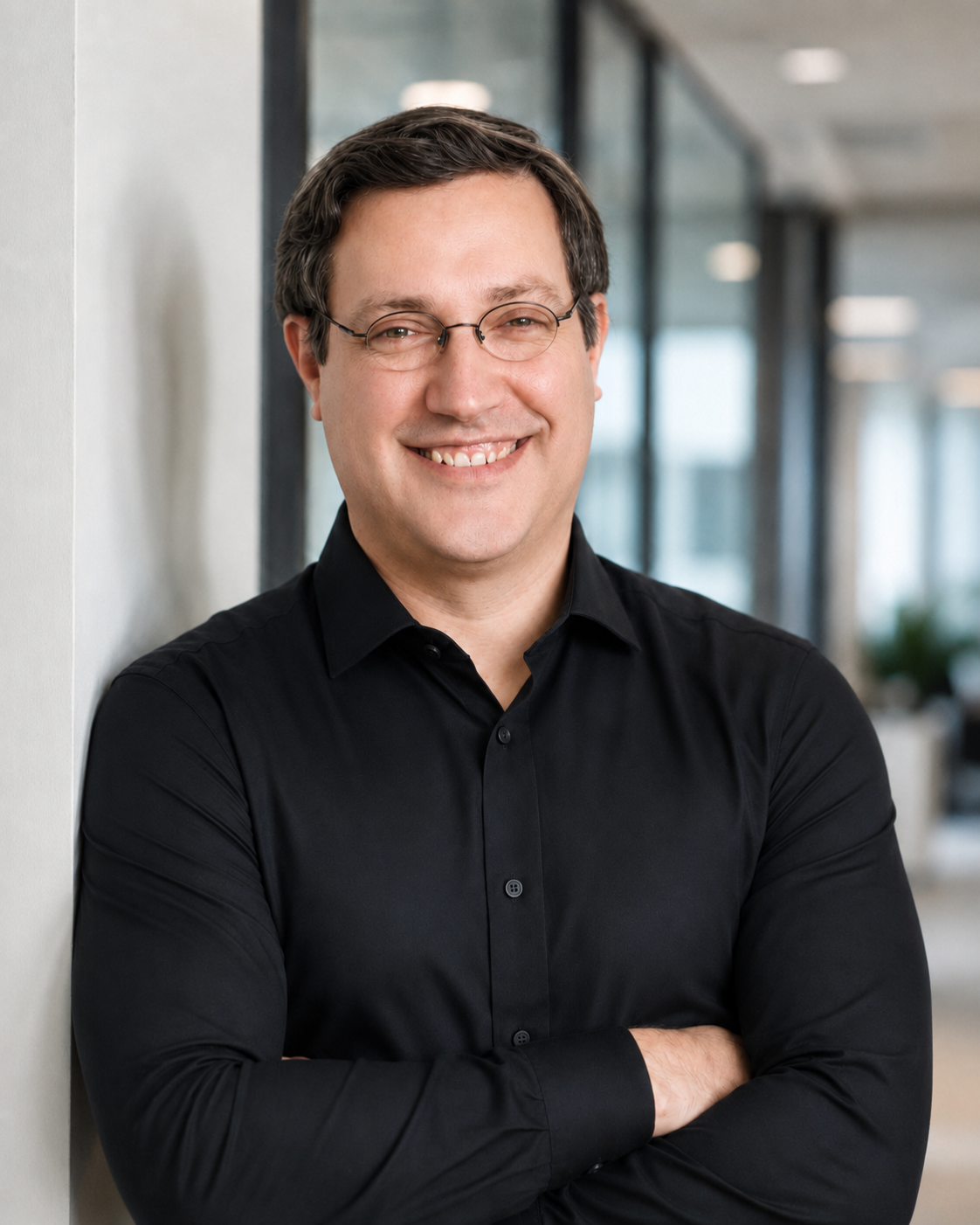 Profile picture of Andrew Ross, smiling at the camera. He is wearing a black shirt.