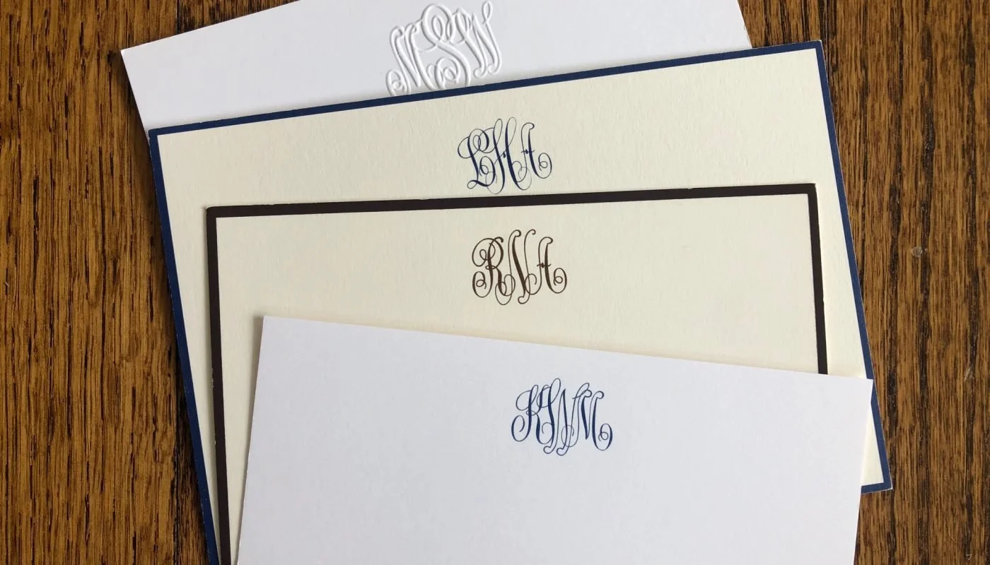 Embossed monogram stationery and custom note cards designed by Whimsy boutique in Greenville, Delaware featuring navy and cream paper details.