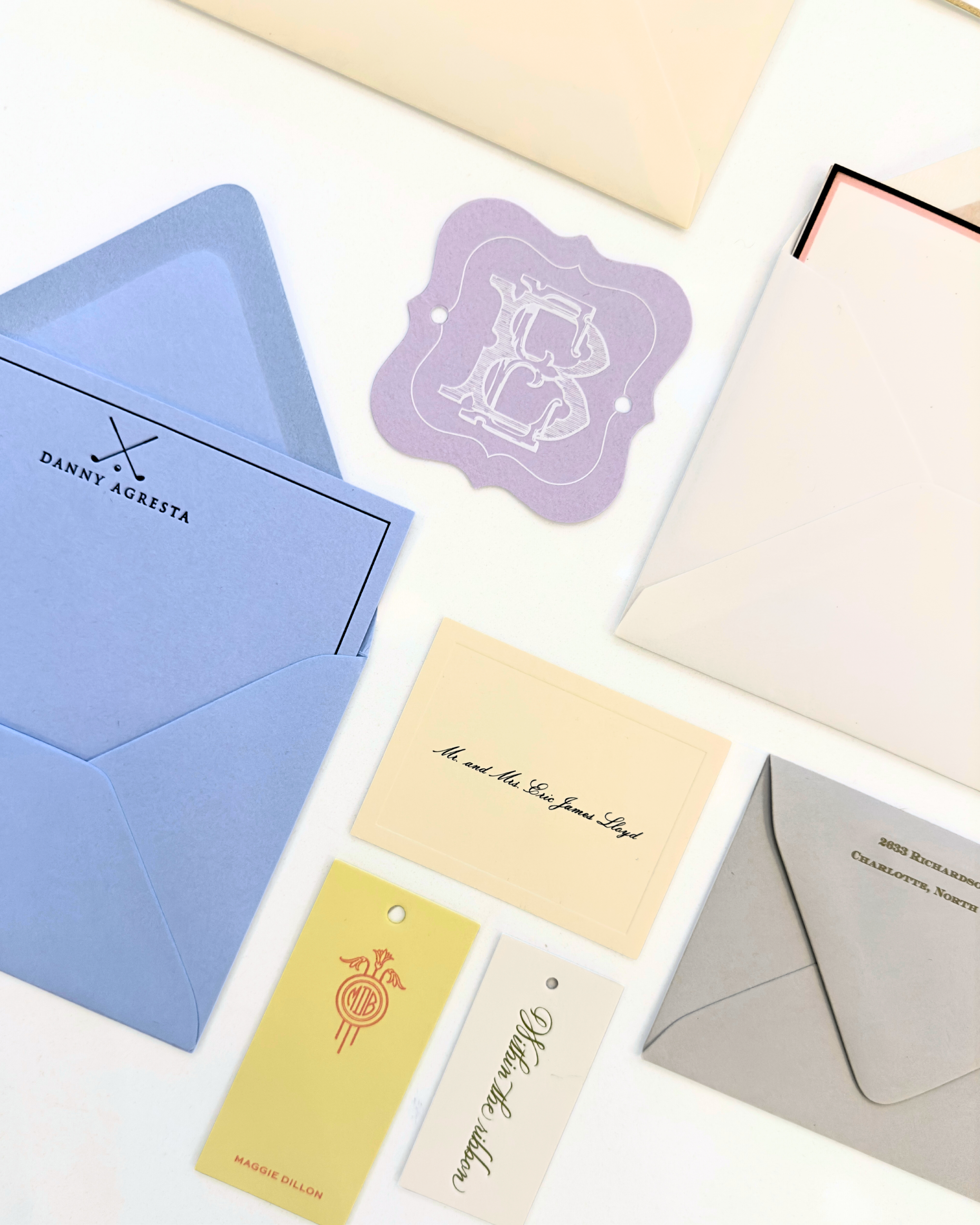 Personalized envelope liners, custom monogram tags, and refined wedding paper details created by Whimsy boutique in Greenville, Delaware.