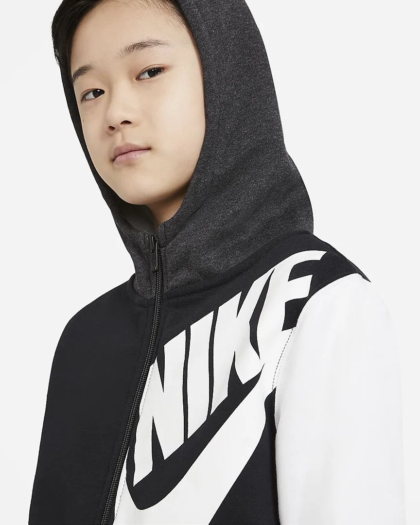 Young person wearing a black and white Nike hoodie with the Nike logo on the front.