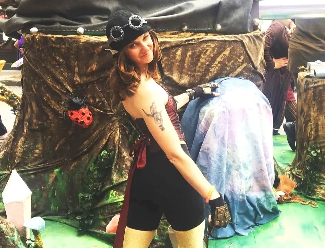 Caroline Hambright next to her bubble blowing steampunk forest parade float Santa Barabara California Summer Solstice Parade 2019