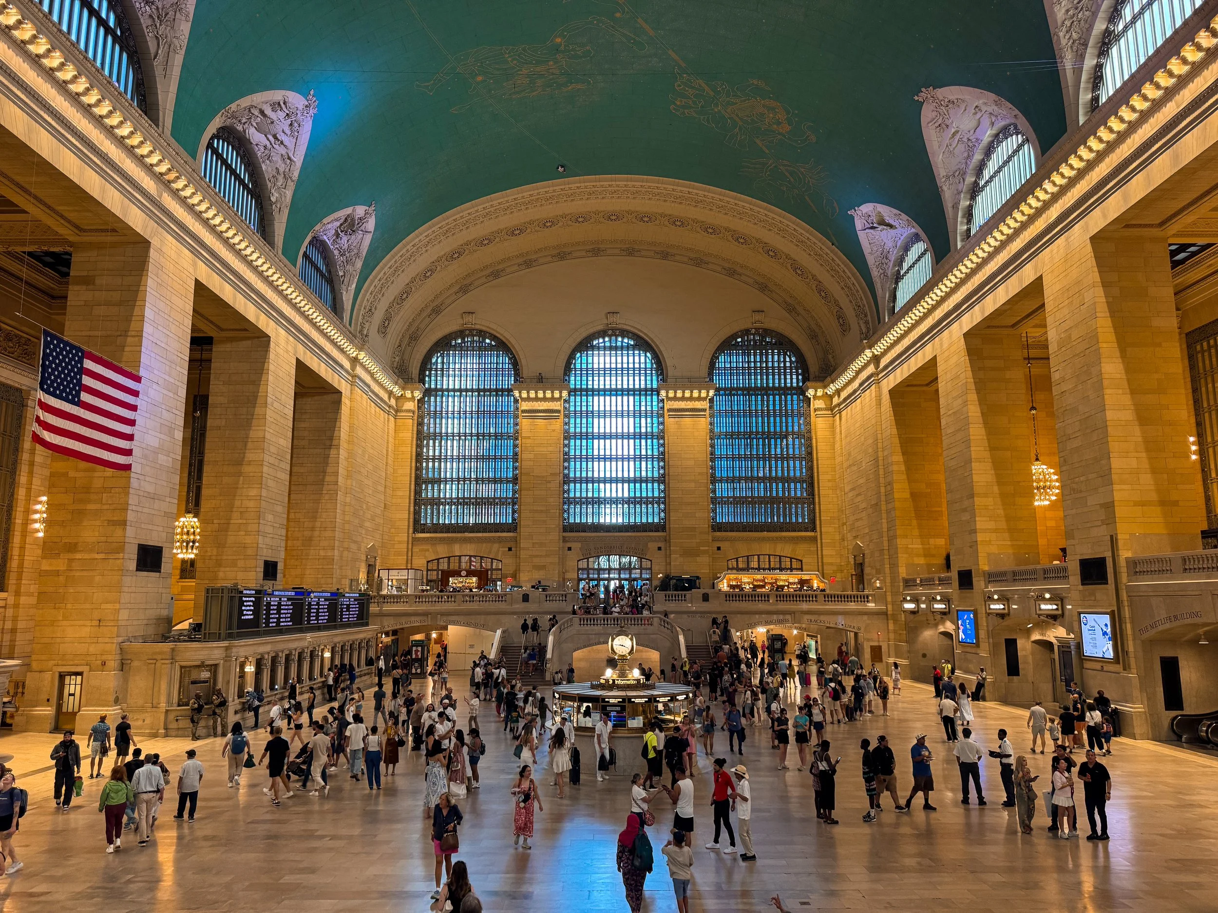Grand Central Terminal main concourse with arched windows, celestial ceiling and the central clock in New York City