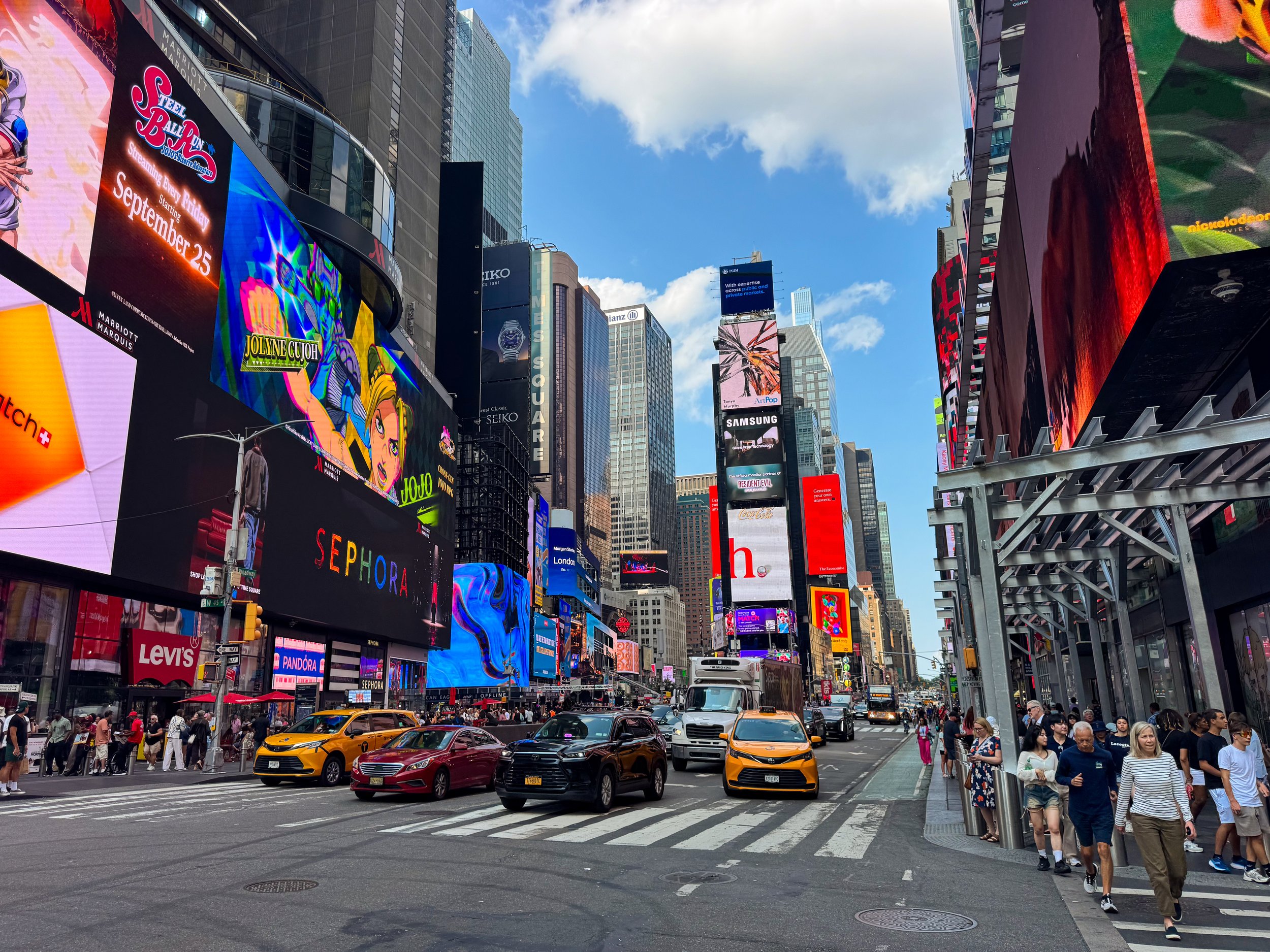 Crowds and bright digital billboards filling Times Square in Midtown Manhattan, New York City